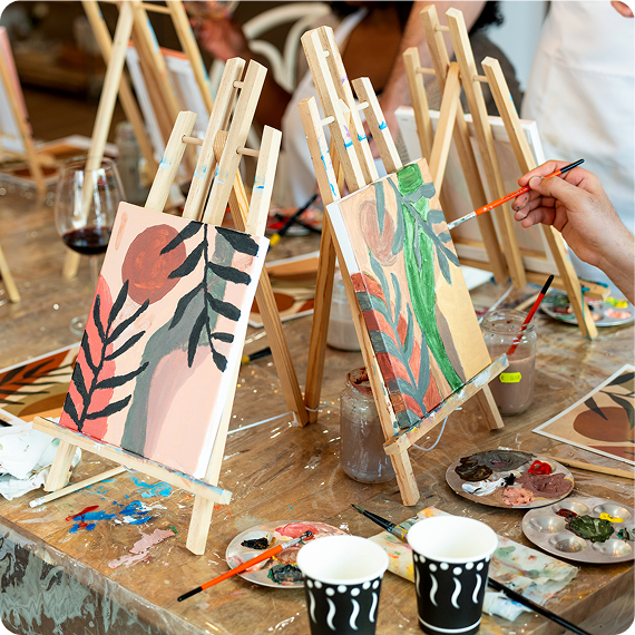 Painting class easels with canvases and palettes